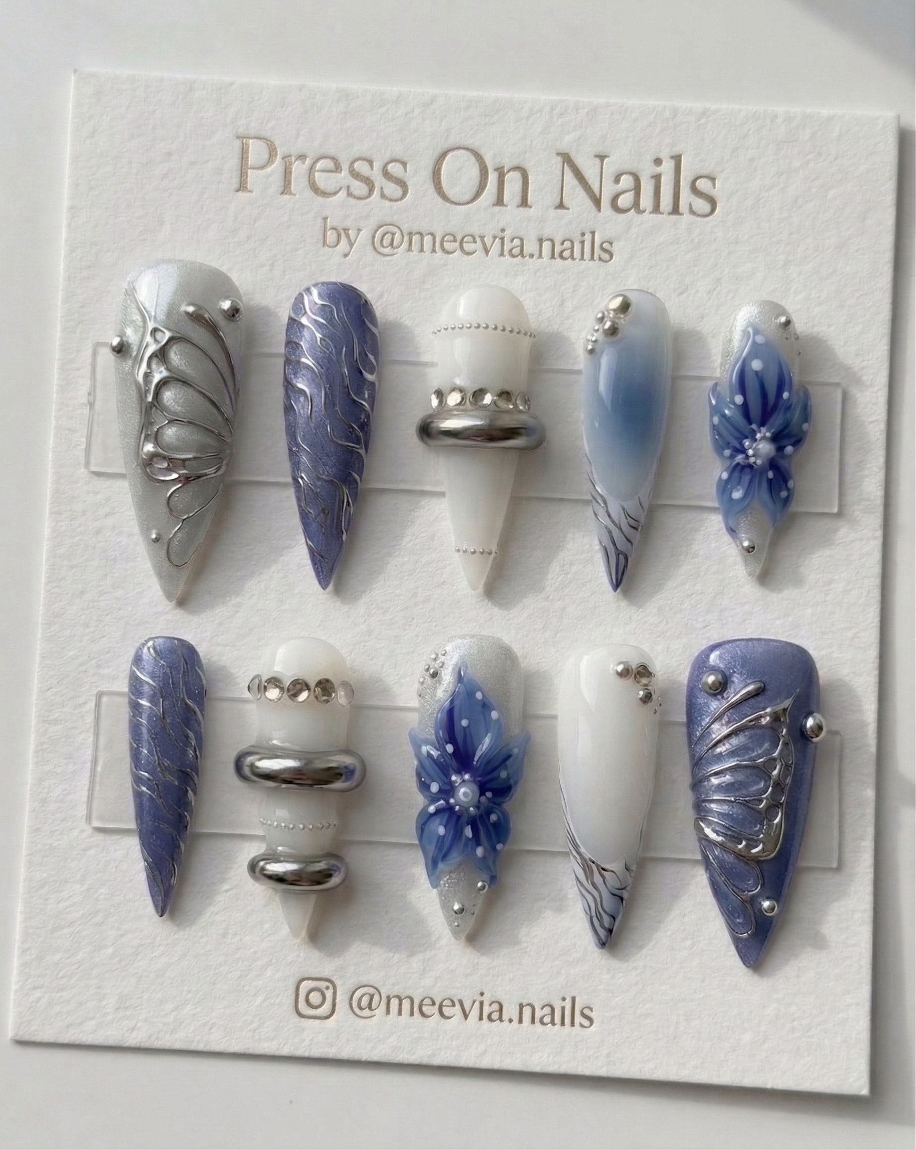 Long stiletto press on nails with blue 3D flowers and silver chrome butterfly wing designs