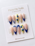 Almond-shaped press-on nail set with 3D blueberries and navy blue French tips with polka dots