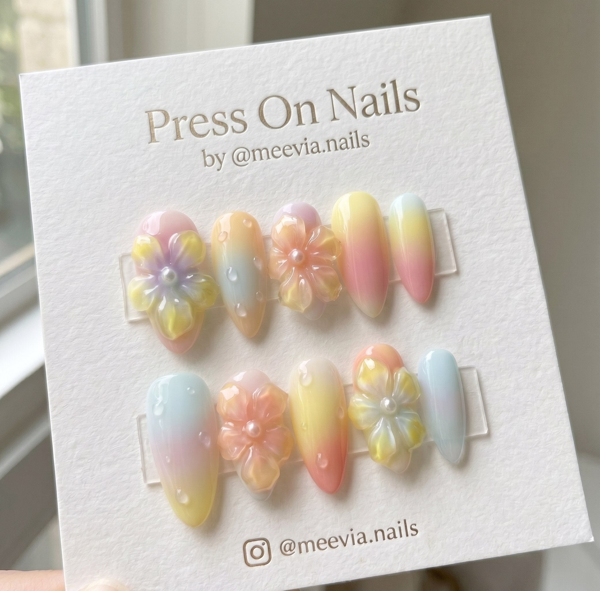 Almond-shaped pastel gradient press on nails with 3D flowers and water droplets
