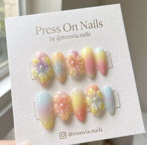 Almond-shaped pastel gradient press on nails with 3D flowers and water droplets
