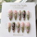 Stiletto-shaped floral and butterfly 3D press-on nails with rhinestone accents