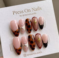 Almond-shaped tortoiseshell press-on nail set with 3D gold stars and silver studs