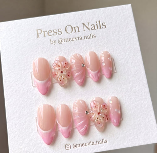 Almond-shaped pink French tip press-on nail set with 3D floral and shell art