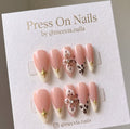 Almond-shaped French tip press on nails with 3D floral art and leopard print accents