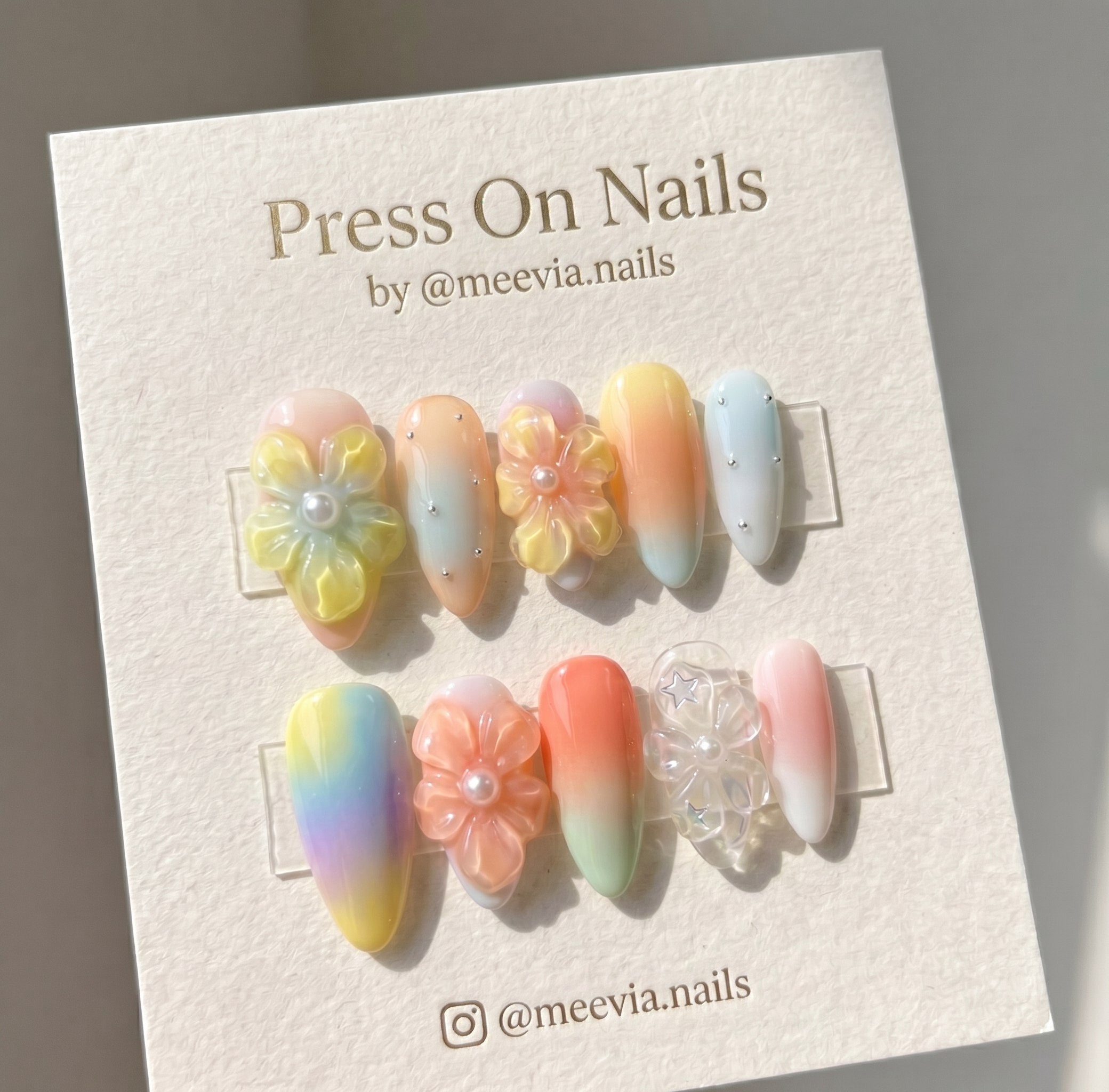 Almond-shaped pastel press-on nails with 3D floral art and delicate embellishments
