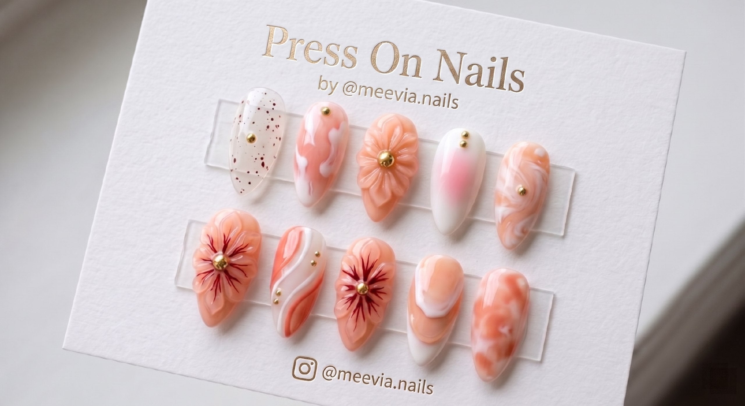 Almond-shaped peach and white 3D floral press-on nail set with gold studs