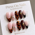 Almond-shaped tortoiseshell press-on nails featuring gold star accents and French tips
