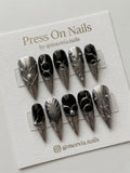 Stiletto-shaped black and silver chrome press on nails with 3D liquid metal art