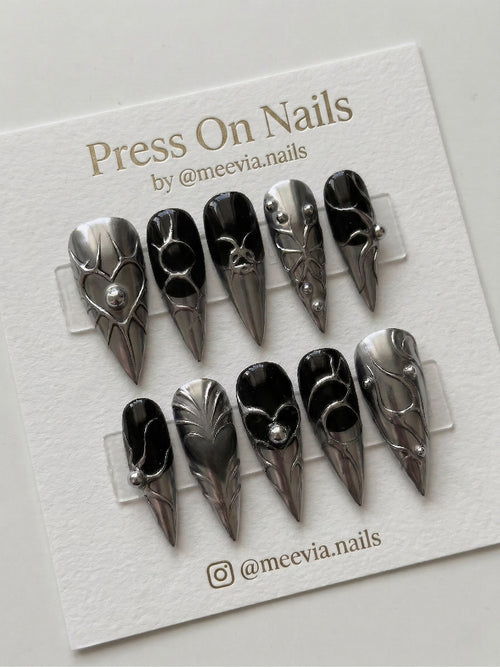 Stiletto-shaped black and silver chrome press on nails with 3D liquid metal art