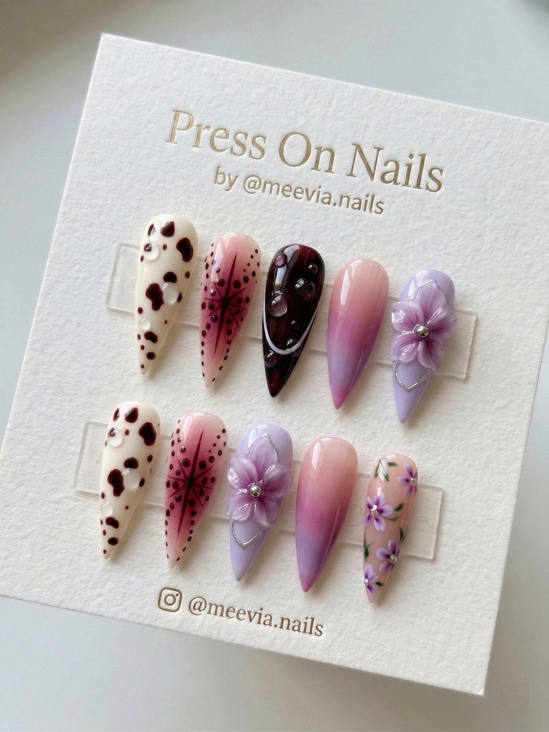 Stiletto-shaped purple and pink press-on nail set with 3D flowers and cow print accents