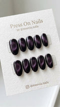 Oval-shaped deep purple cat eye press-on nail set with a shimmering galaxy finish