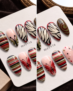 Glossy red and olive striped press-on nails with butterfly and zebra-inspired designs