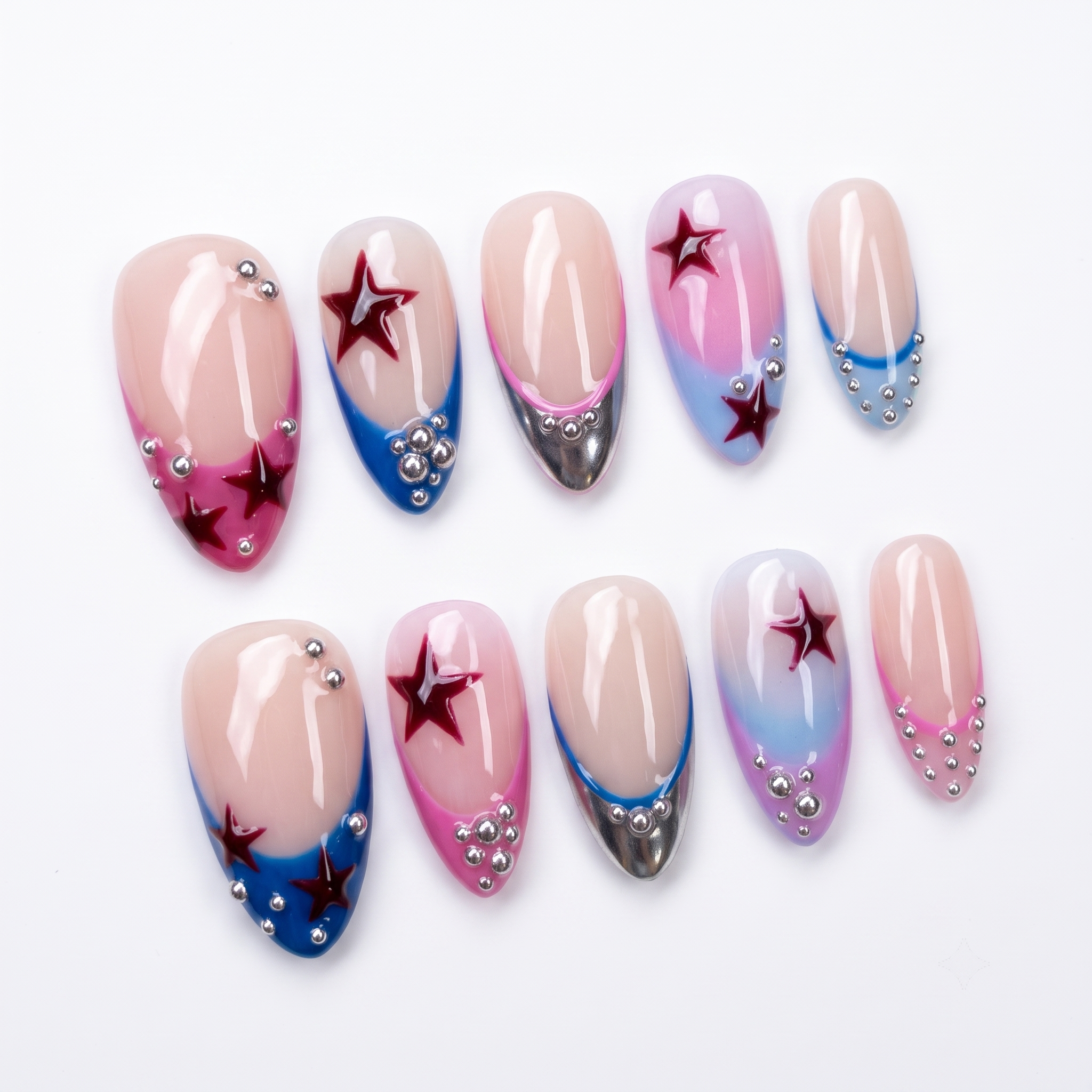 A set of press-on nails featuring a French tip design with red star accents and silver beads on a nude base.