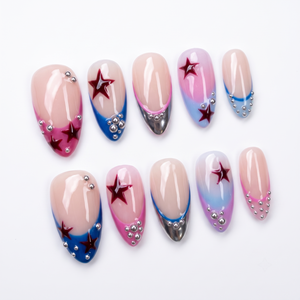 A set of press-on nails featuring a French tip design with red star accents and silver beads on a nude base.