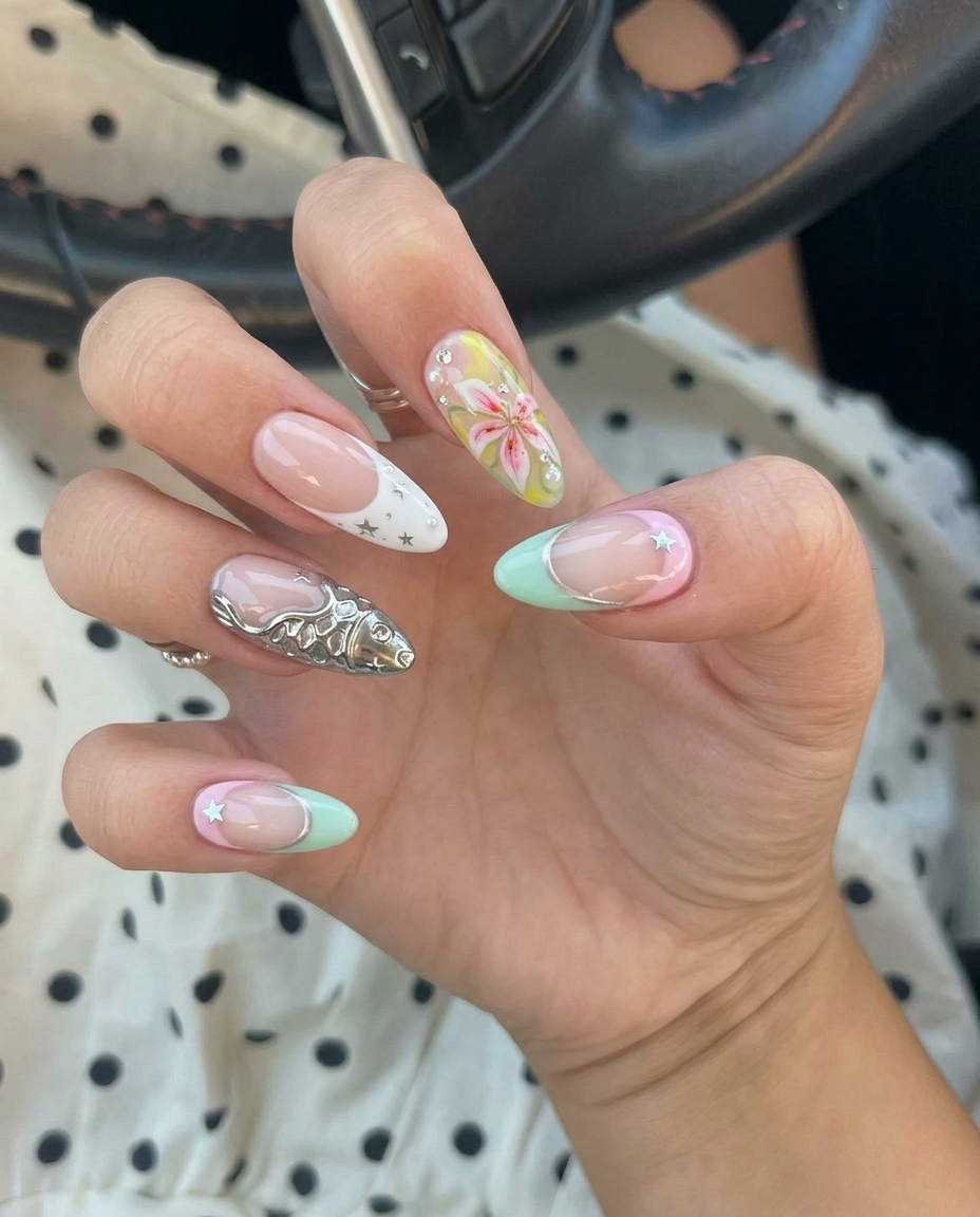 Pastel mermaid press-on nails featuring silver metallic fish scales, colorful star gems, and a pink lily flower design.