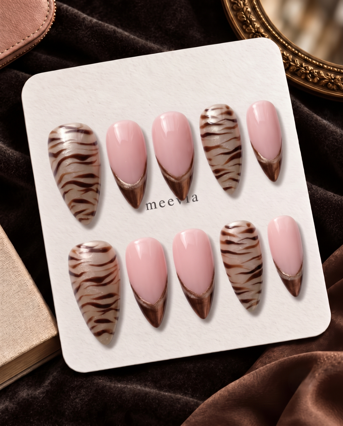 Taupe zebra stripe French tip press-on nails with pink center panels and shimmer accents