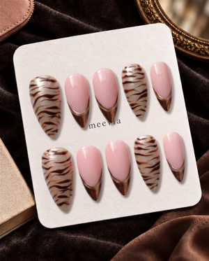 Taupe zebra stripe French tip press-on nails with pink center panels and shimmer accents
