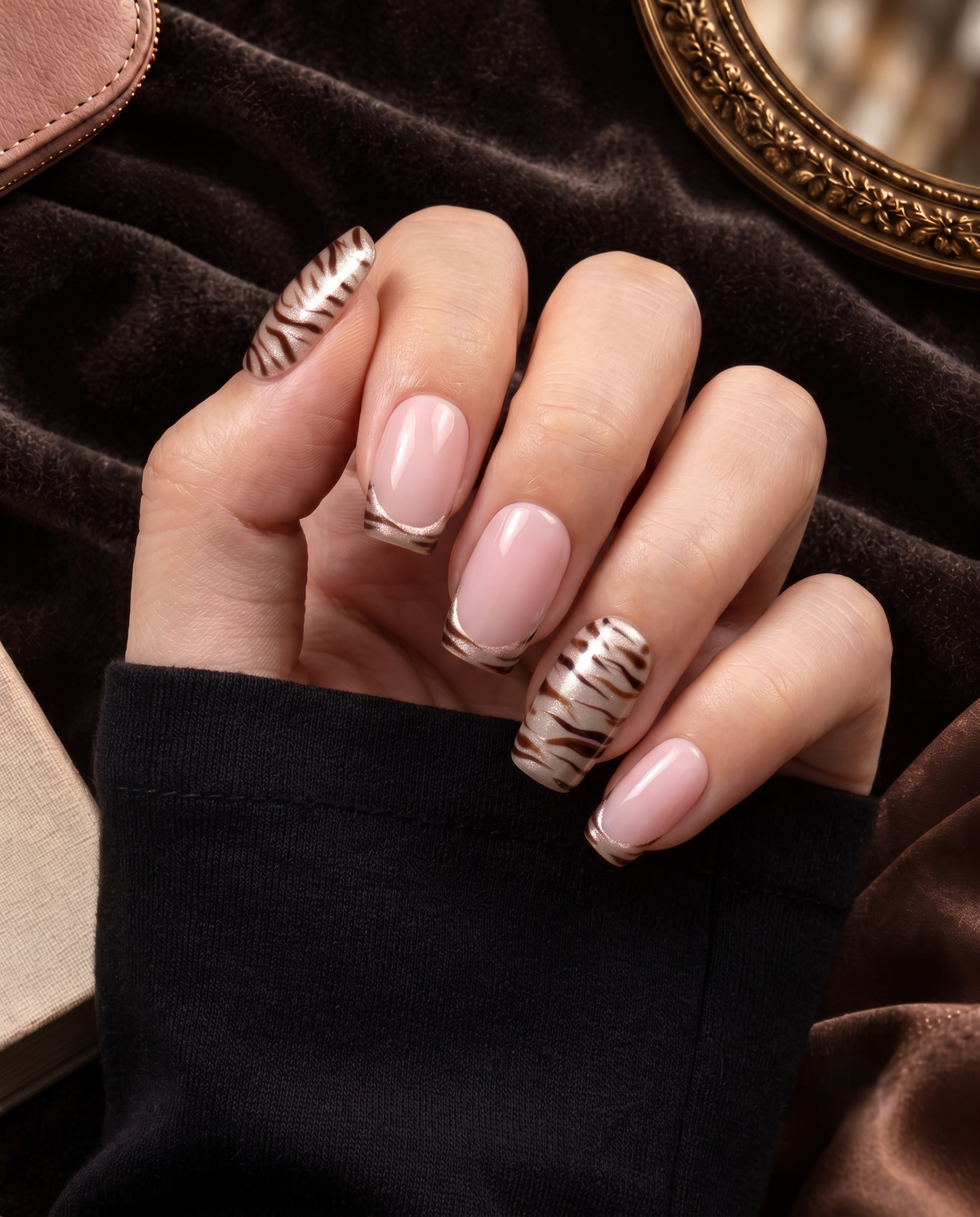 Taupe zebra stripe French tip press-on nails with pink center panels and shimmer accents