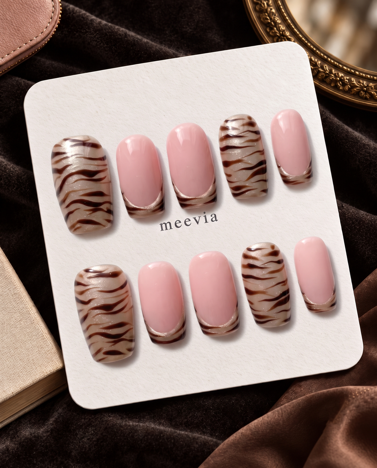 Taupe zebra stripe French tip press-on nails with pink center panels and shimmer accents