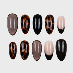 A collection of press-on nails featuring tortoise shell patterns, solid black, and sheer neutral tips.