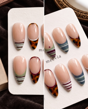 Nude press-on nails with tortoiseshell French tips and multicolor striped designs