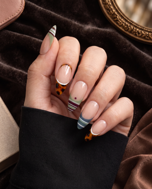 Nude press-on nails with tortoiseshell French tips and multicolor striped designs