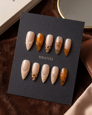 Nude and amber tortoiseshell swirl French tip press-on nails with spotted and rhinestone accents