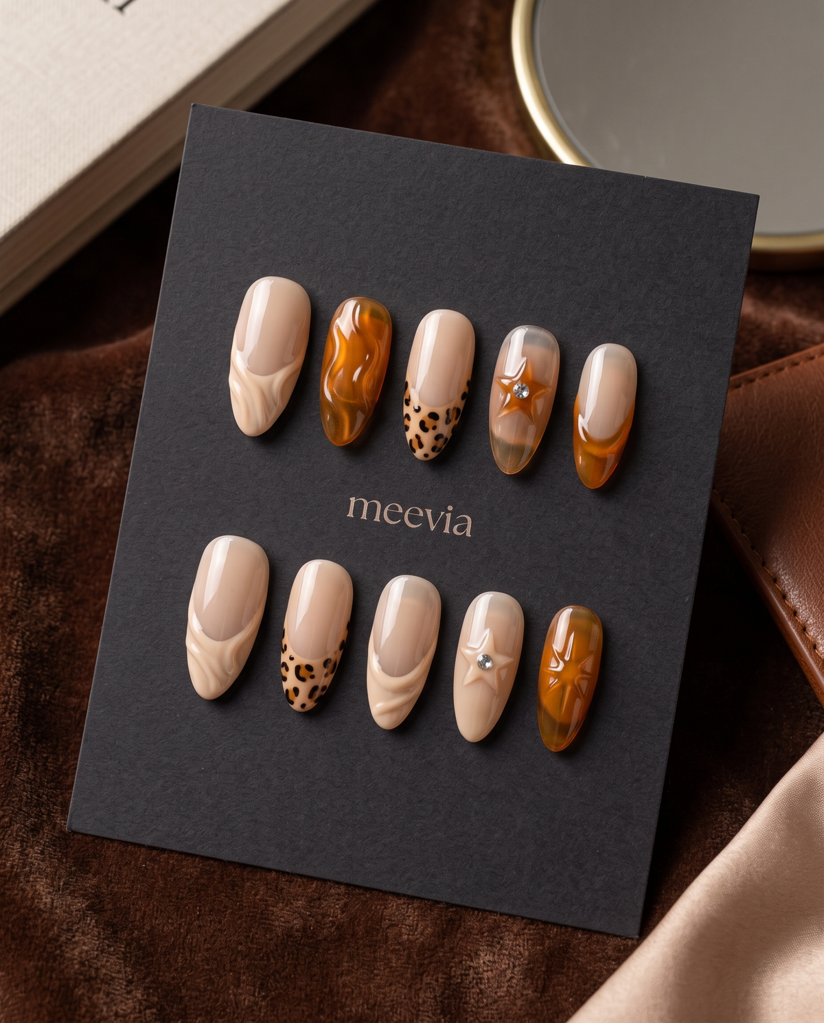 Nude and amber tortoiseshell swirl French tip press-on nails with spotted and rhinestone accents